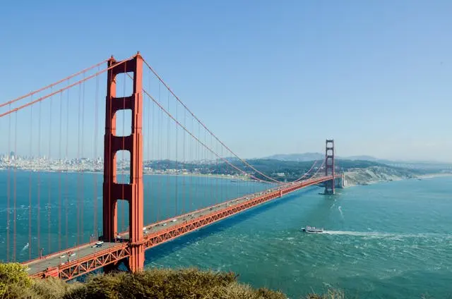 Golden Gate Bridge at sunrise with fog drifting through the towers.