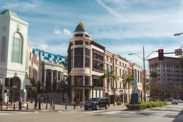 Rodeo Drive luxury boutiques with palm trees and high-end storefronts.