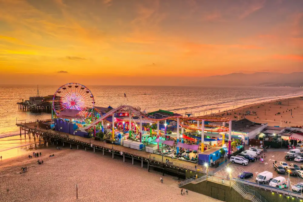 Santa Monica Pier with Ferris wheel and ocean waves.